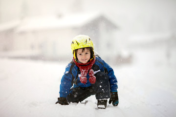 Fototapeta na wymiar Happy baby boy playing in the snow
