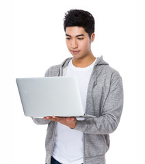 Asian man read on the laptop computer