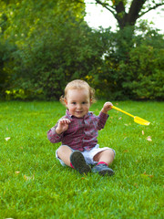 Little boy playing with a paddle.