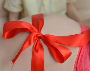 Pregnant woman with a red tape