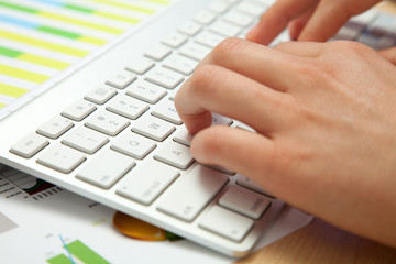 Side view of hands typing