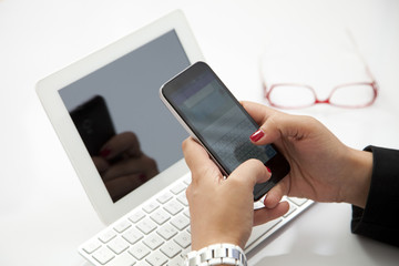Businesswoman entrepreneur using smartphone and laptop