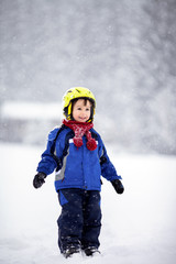 Fototapeta na wymiar Happy baby boy playing in the snow