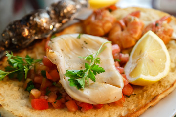 Grilled squid and shrimps on toast closeup