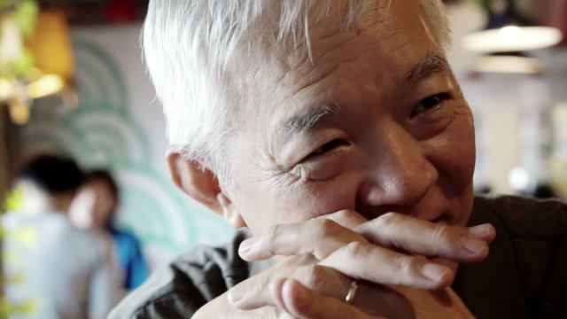 Asian senior guy talking happy 

