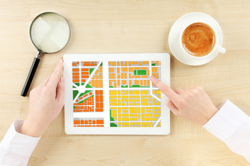 Woman using tablet with map gps navigation application, top view