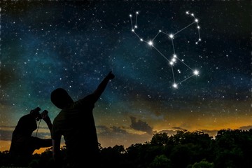 Orion constellation on night sky. Astrology concept. Silhouettes of adult man and child observing night sky. - obrazy, fototapety, plakaty