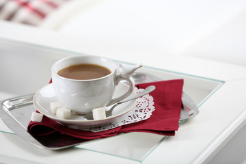 Cup of coffee on table in living room