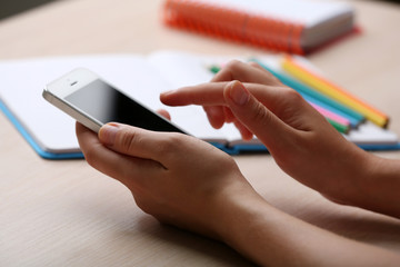 Woman write on notebook on workplace close up