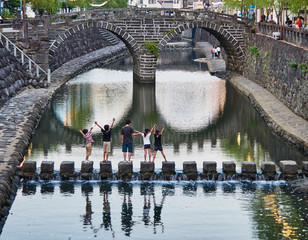 A group of kids enjoying the Megane bridge in Nagasaki Japan