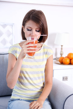 Young beautiful woman drinking fresh juice