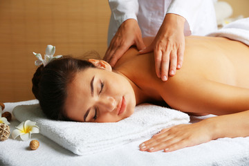 Fototapeta na wymiar Young woman on massage table in beauty spa salon