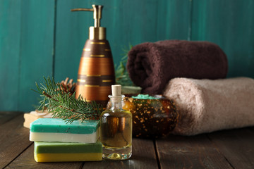 Essential oil of pine, handmade soap and cream with pine extract and spa treatments on wooden background