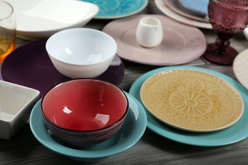 Different tableware on wooden table close up