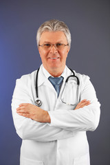 Doctor with stethoscope on colorful background