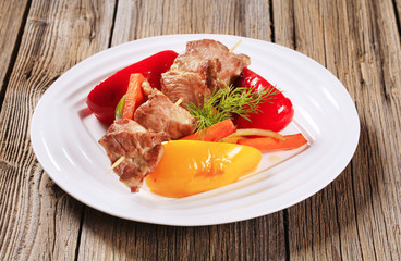 Roasted meat on skewer and vegetables