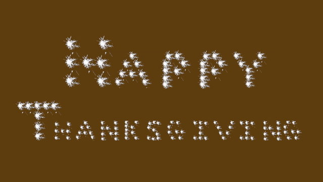 Happy Thanksgiving in white sparkler, block letters on brown. 