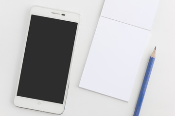 smartphone and blank notepad