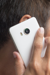 asian man holding cellphone and talking