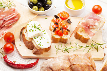 Bruschetta with cheese, tomatoes and prosciutto