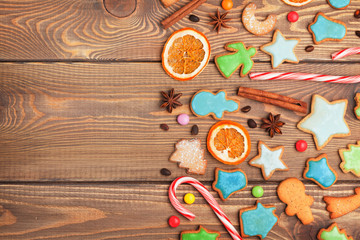 Christmas wooden background with candies, spices, gingerbread co
