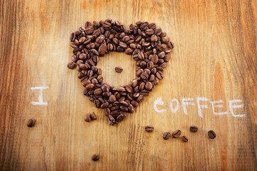 Coffee beans on wooden background.
