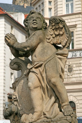 Fototapeta na wymiar Statue on the Holy Trinity Column (Plague Column) at Lesser Town Square. Prague, Czech Republic