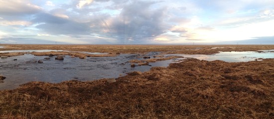 Iceland landscape with melting snow water during sunset Panorama