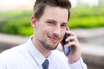 Caucasian young businessman chat on mobile phone