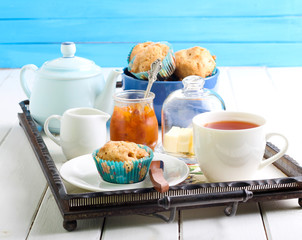 Muffin, cup of tea and jam