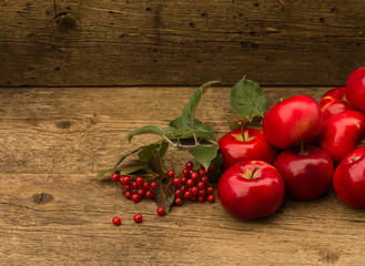 red apples with leaves on wooden background