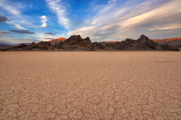 Mojave Desert at sunset. View of the Racetrack Playa Dry Lake in Death Valley, California - obrazy, fototapety, plakaty
