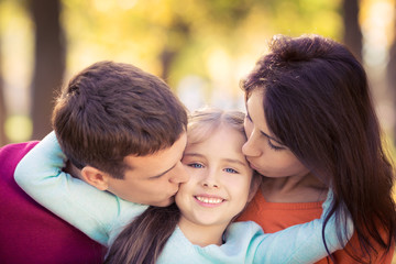 Happy family in autumn park