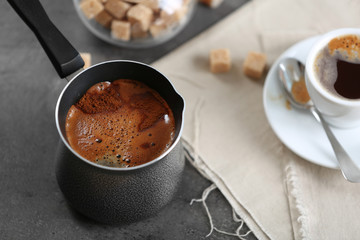 Turk of flavored coffee on table with napkin, closeup