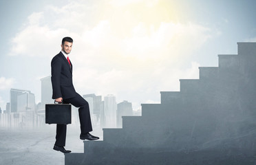 Businessman climbing up a concrete staircase concept