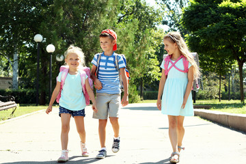 Fototapeta premium Happy active children with bags outdoors