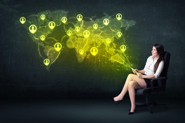 Plakat Businesswoman in office with tablet and social network world map