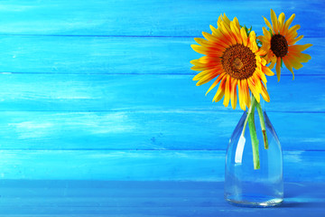 Beautiful sunflowers in vase on wooden background - Powered by Adobe