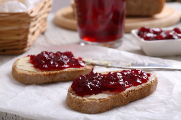 Fresh toast with butter and jam on table close up