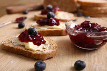 Fresh toast with butter and jam on table close up
