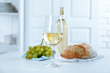 Still life of wine, grape and bread on light background