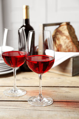 Still life of wine and bread on light background