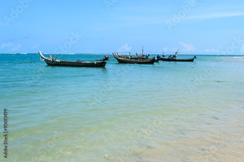 Long Tail Boats Moored At Nai Yang Beach Et Thailand With Blue Long Tail Boats Moored At Nai Yang Beach Et Thailand With Blue Sky Background