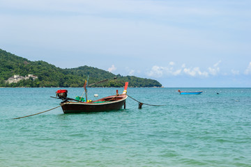 Naklejka na ściany i meble Long tail Boats moored at Nai Yang Beach, Phuket Thailand with blue sky background