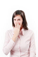 Young business woman covering with hand her mouth.