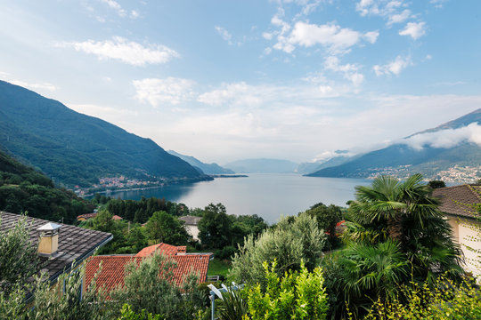  Laghetto di Piona, penincula Olgiasca  in Italy, Alps, Europe. Como lake.  rural mountain landscape with houses and red-tiled roofs.