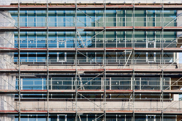 Staircase and scaffolding on a construction site,covered with mesh.