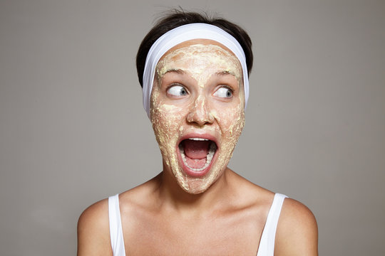 skreaming woman in moment of facial treatment