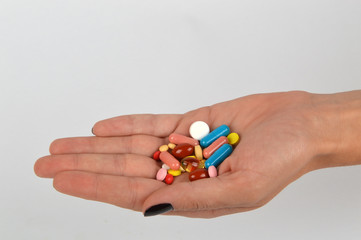  Woman holding different kind of pills in her hand