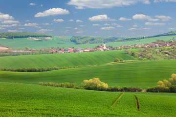 Panorama of Little town on the green hills, blue sky, smalll